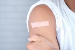 A person with a plaster on their upper arm. Image by Towfiqu Barbhuiya via Pexels.